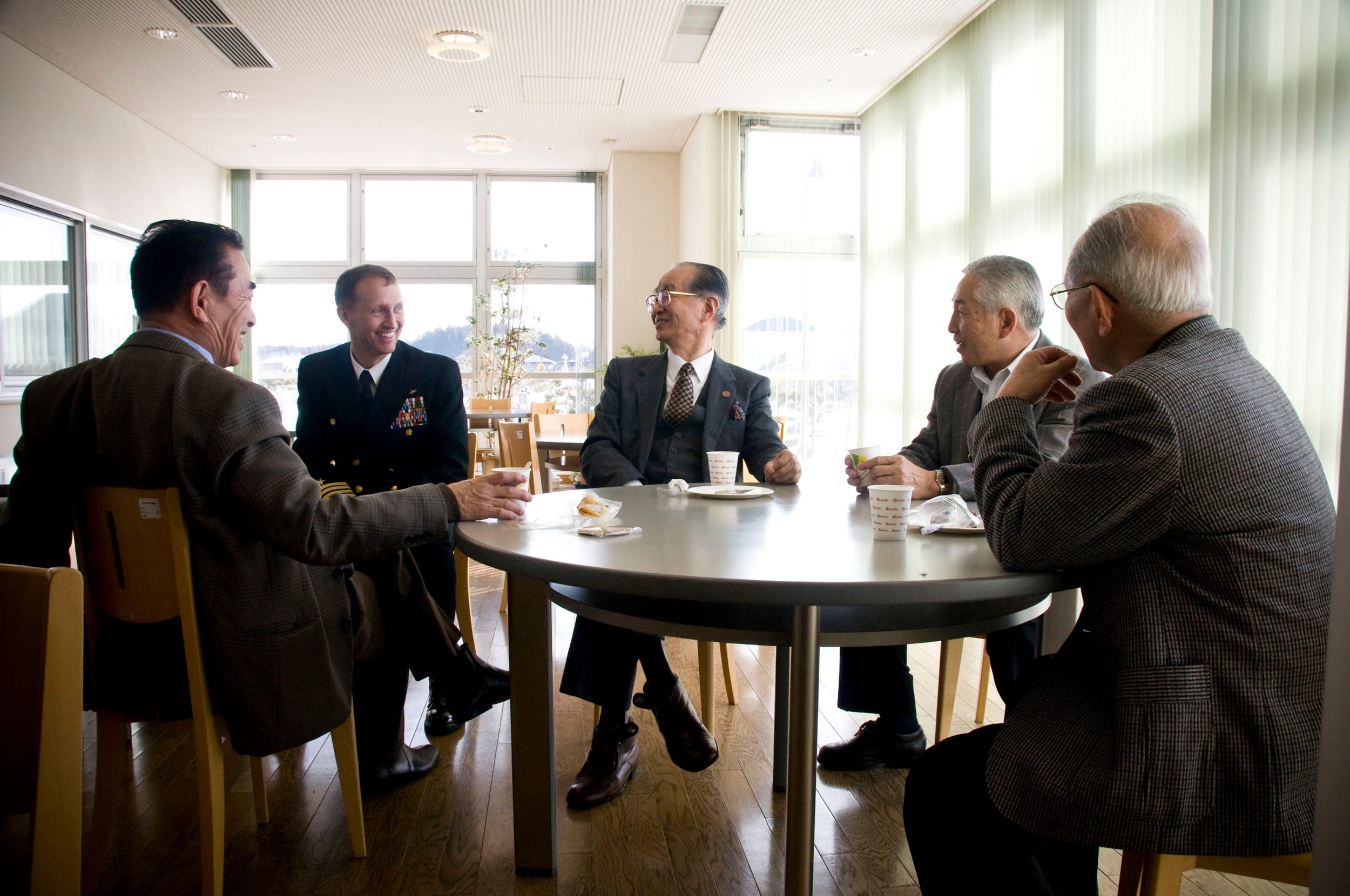 Japanese business men sitting at round table