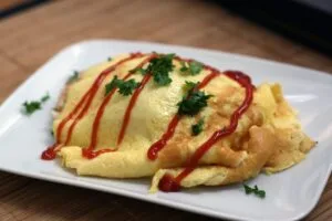 A plate of Japanese omurice topped with ketchup